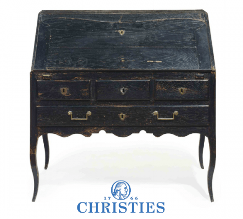 A FRENCH PROVINCIAL EBONIZED OAK SLANT-FRONT BUREAU